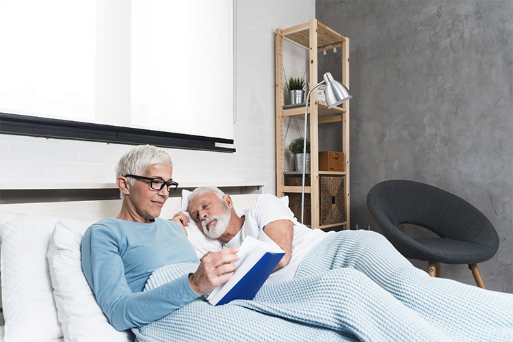 senior-couple-reading-books-at-bed